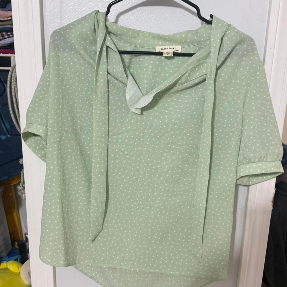 Green and white polka dot blouse